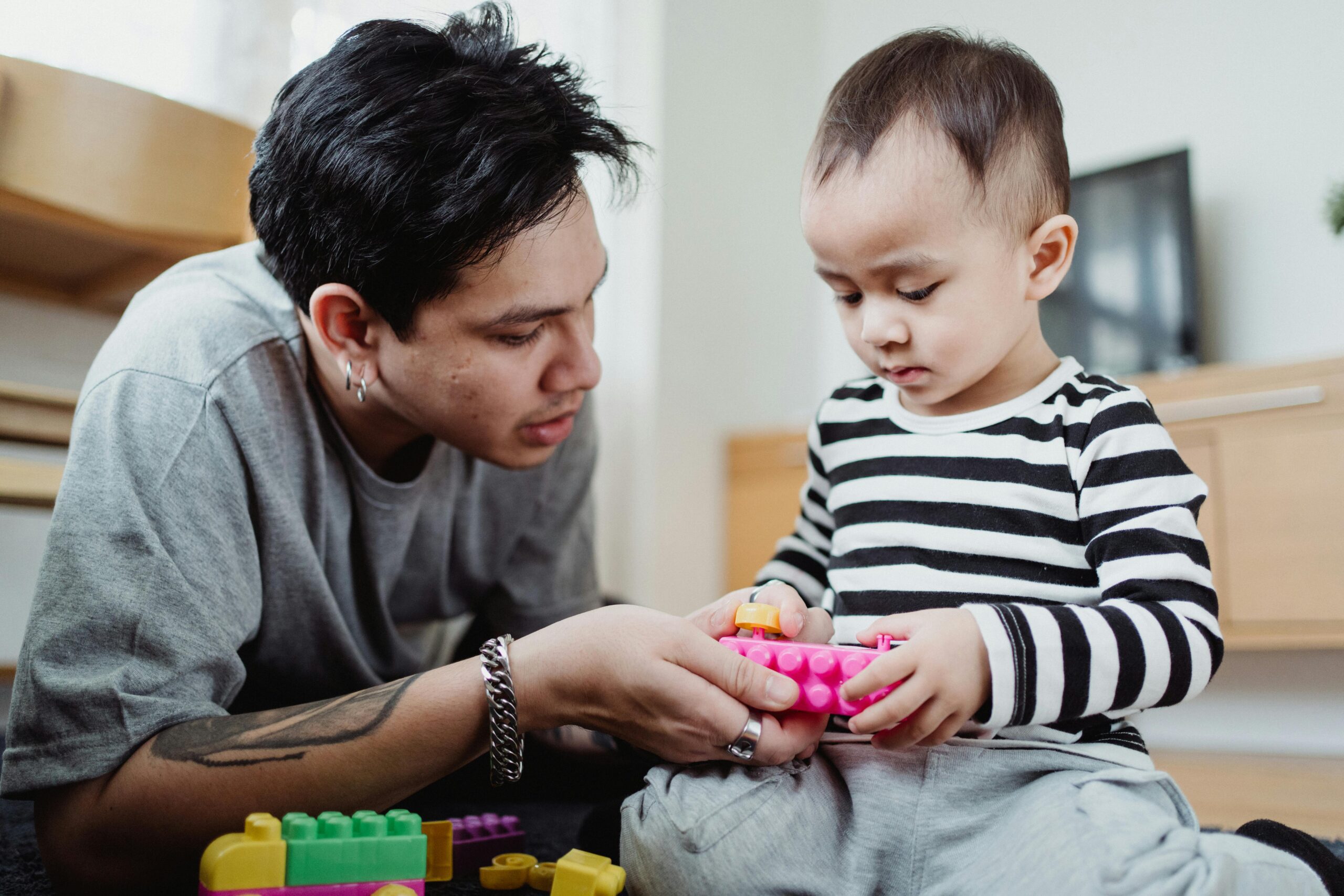 Parent taking a calming breath during a child tantrum, showing how to handle strong willed child without shouting